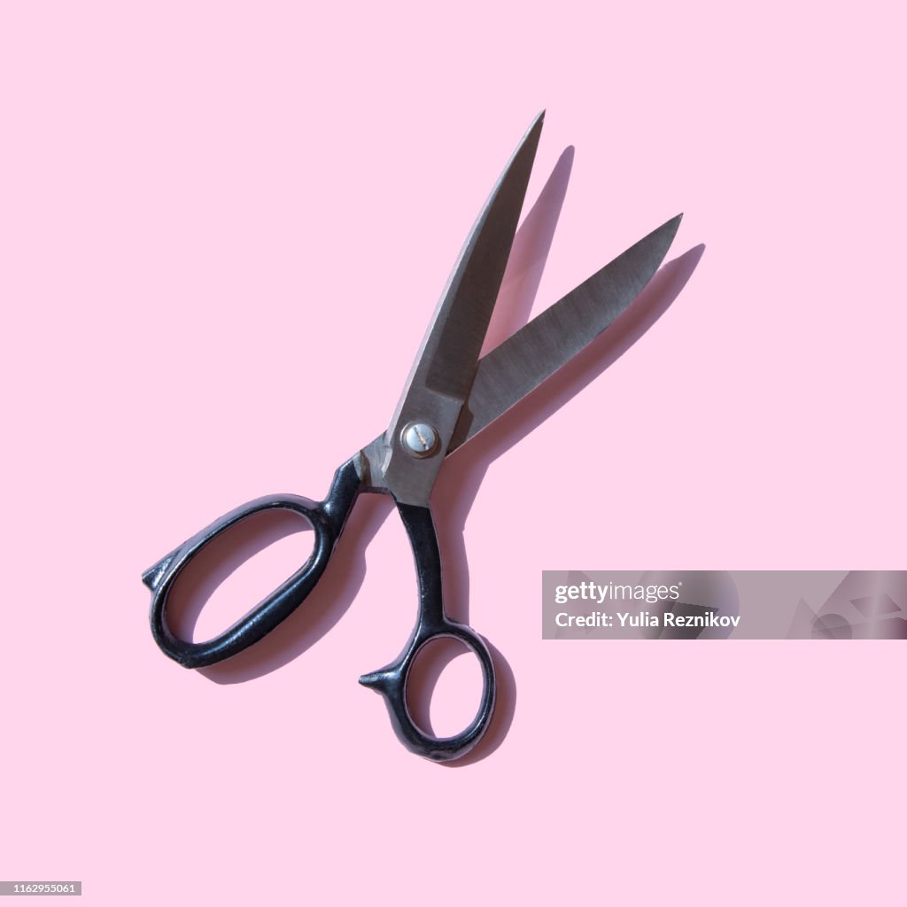 Vintage scissors on pink background