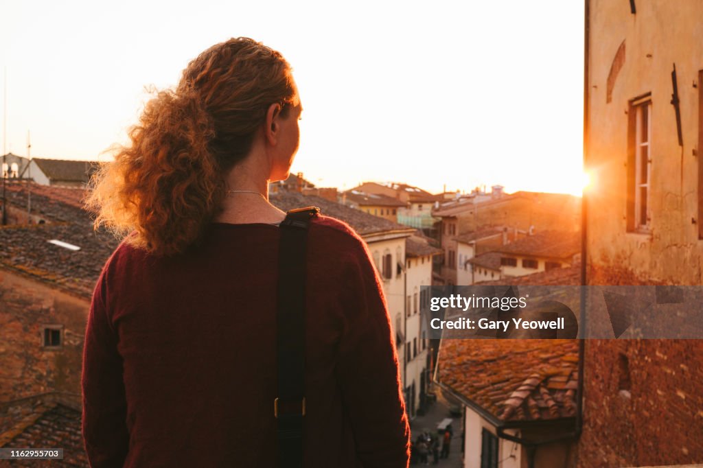 Woman looking out over rooftops in San Miniato