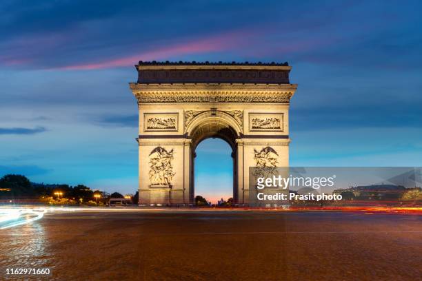 champs-elysees and arc de triomphe at night in paris, france. architecture and landmarks of paris. - arc de triomphe stock-fotos und bilder