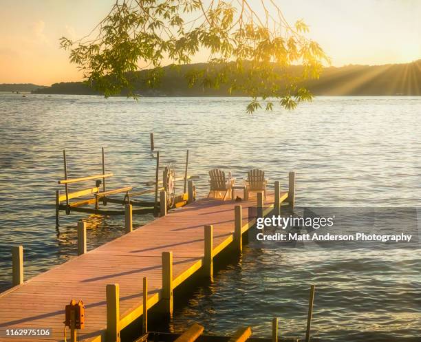 lake geneva pier with chairs at sunset - wisconsin fotografías e imágenes de stock