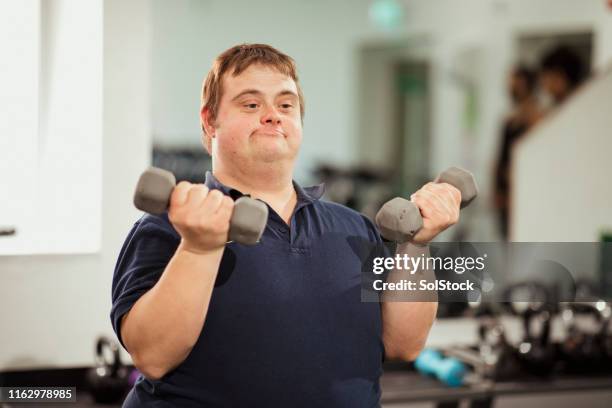 focused on getting fit - down syndrome adult exercise stock pictures, royalty-free photos & images