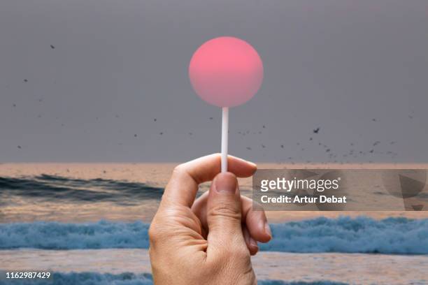 creative picture of sun like a lollipop in the beach. - blickwinkel der aufnahme stock-fotos und bilder