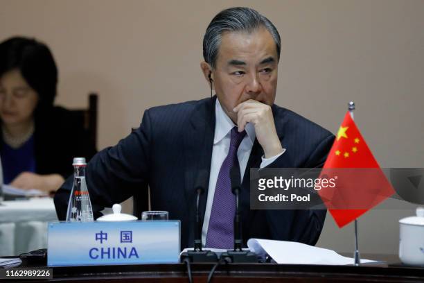 Chinese Foreign Minister Wang Yi speaks with South Korean Foreign Minister Kang Kyung-wha and Japanese Foreign Minister Taro Kono during a meeting of...