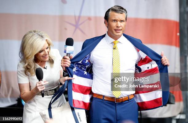 Anchor Pete Hegseth and meteorologist Janice Dean are on stage as Phil Vassar performs on "FOX & Friends" All-American Summer Concert Series on July...