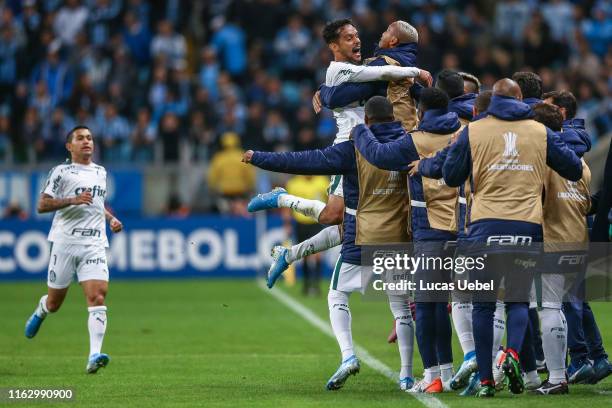 Gustavo Scarpa of Palmeiras celebrates with teammates after scoring the first goal of his team during the match Gremio v Palmeiras as part of Copa...