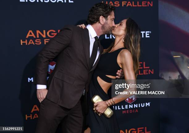 Scottish actor Gerard Butler and girlfriend US actress Morgan Brown kiss as they arrive for the Los Angeles premiere of "Angel Has Fallen" at the...