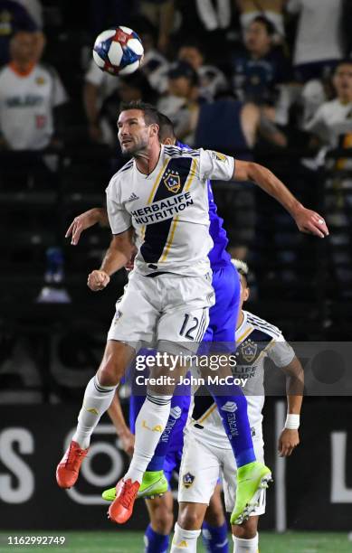 Chris Pontius of Los Angeles Galaxy heads the ball away from Pablo Aguilar of Cruz Azul in the first half at Dignity Health Sports Park on August 20,...