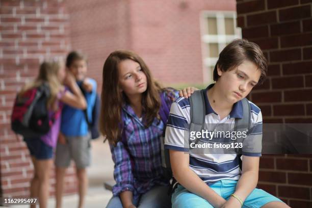 comforting friend after being bullied. - peer pressure stock pictures, royalty-free photos & images