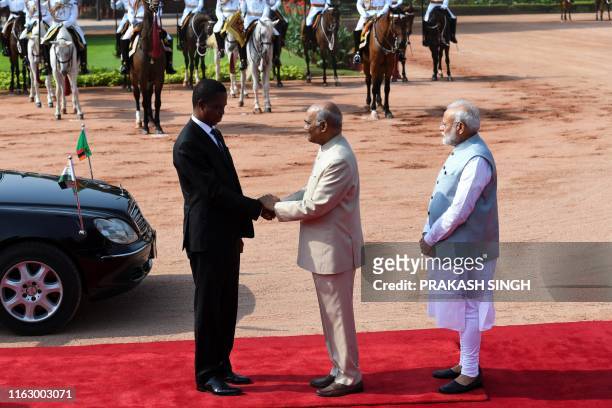 Zambia's President Edgar Chagwa Lungu shakes hands with his Indian counterpart Ram Nath Kovind as India's Prime Minister Narendra Modi looks on...