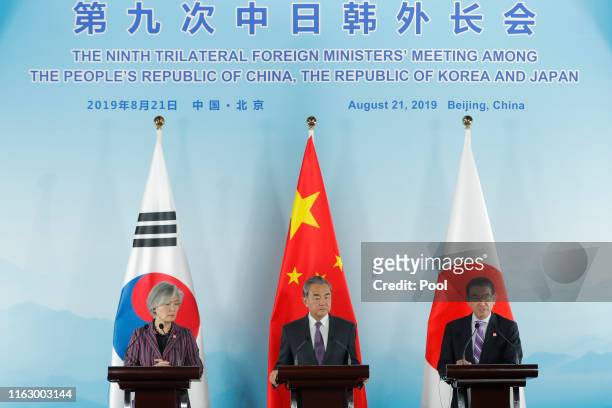 Chinese Foreign Minister Wang Yi , South Korean Foreign Minister Kang Kyung-wha and Japanese Foreign Minister Taro Kono attend a press conference...