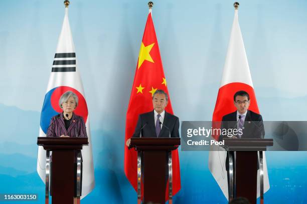 Chinese Foreign Minister Wang Yi , South Korean Foreign Minister Kang Kyung-wha and Japanese Foreign Minister Taro Kono attend a press conference...