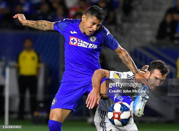 Julio Dominguez of Cruz Azul and Chris Pontius of Los Angeles Galaxy battle for the ball in the second half at Dignity Health Sports Park on August...