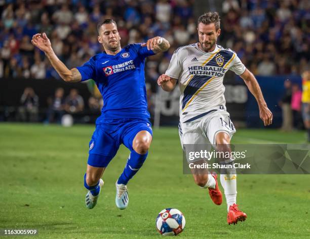 Chris Pontius of Los Angeles Galaxy moves the ball upfield as Edgar of Cruz Azul defends during the Semifinal of the 2019 Leagues Cup match between...