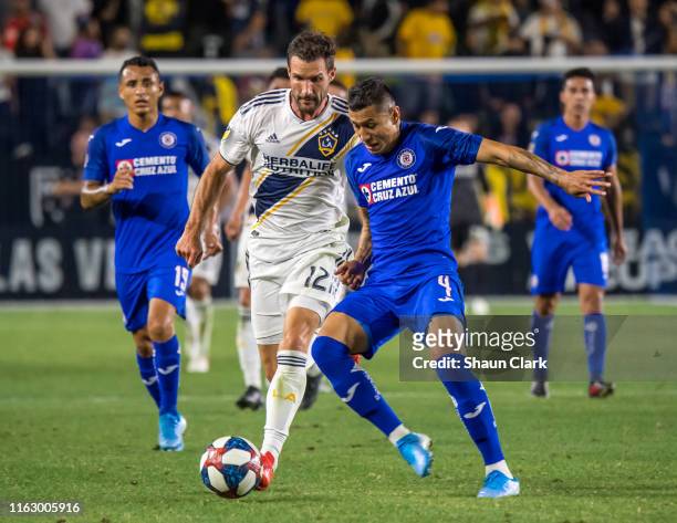 Julio Dominguez of Cruz Azul defends against Chris Pontius of Los Angeles Galaxy during the Semifinal of the 2019 Leagues Cup match between Los...