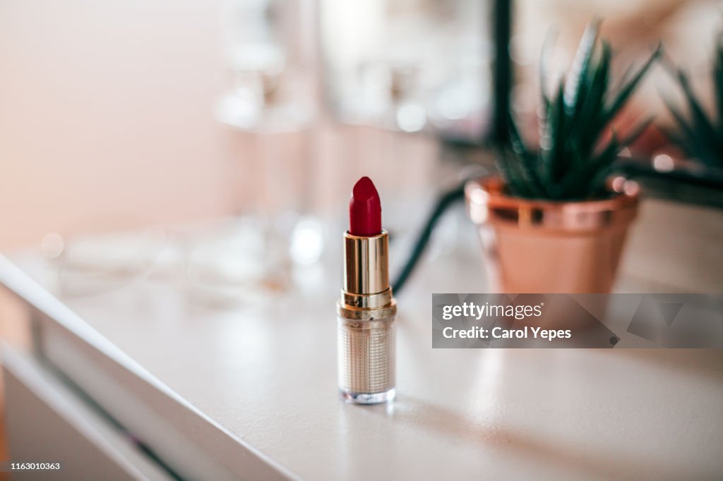 Red lipstick on  dressing table