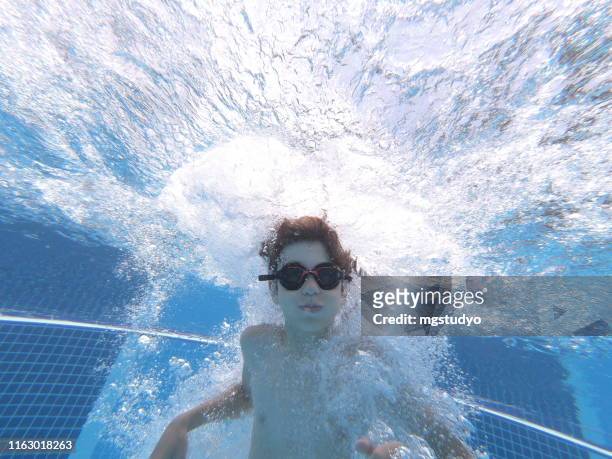 happy boy jumped into swimming pool - cannonball diving stock pictures, royalty-free photos & images