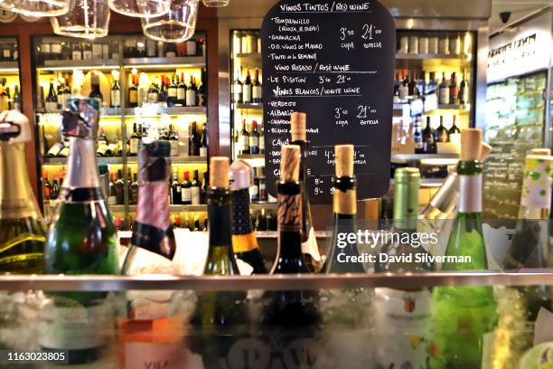 Menu lists Spanish wines by the glass in a stall in the Mercado de San Miguel on March 21, 2019 in the heart of Madrid, Spain's vibrant capital city....