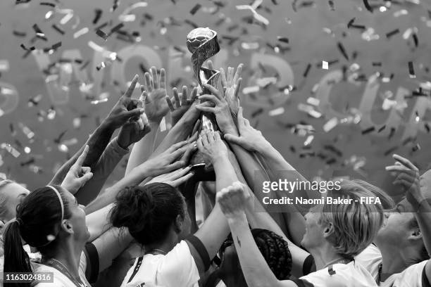 Detailed view of players from USA lift the FIFA Women's World Cup Trophy following her team's victory the 2019 FIFA Women's World Cup France Final...