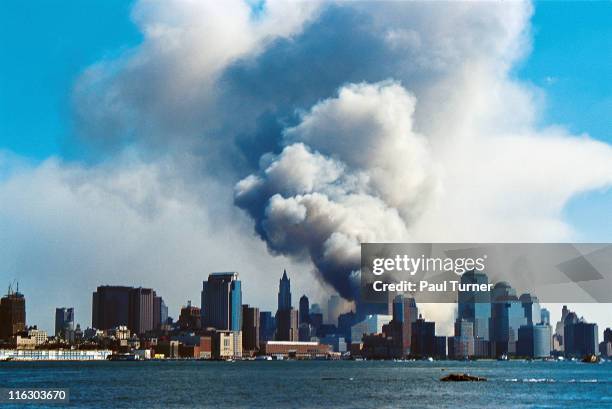 As seen from New Jersey, smoke hangs over South Manhattan after the collapse of the twin towers of the World Trade Center in a terrorist attack, New...