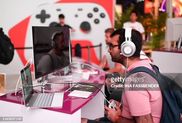 Visitor plays the cloud-gaming based "Doom" at the stand of Google Stadia during the Video games trade fair Gamescom in Cologne, western Germany, on...