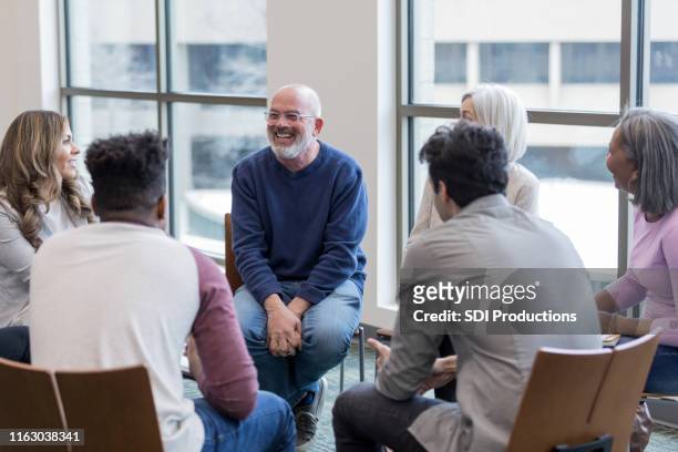 diverse people sit in circle and brainstorm ideas - happiness therapy stock pictures, royalty-free photos & images