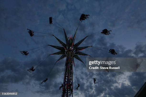 Riders on the Swing Tower at The Canadian National Exhibition, know as simply "The Ex", runs over the last two weeks of the summer since 1879 at the...