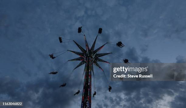 Riders on the Swing Tower at The Canadian National Exhibition, know as simply "The Ex", runs over the last two weeks of the summer since 1879 at the...