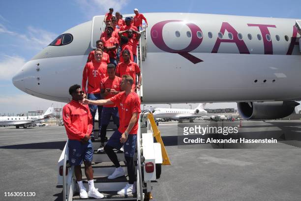 The players of FC Bayern Muenchen pose for a picture in front of a Qatar Airbus 350-900 at the Los Angeles International Airport prior to depart with...