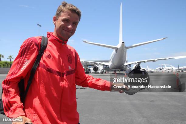 Thomas Mueller of FC Bayern Muenchen smiles at the Los Angeles International Airport to depart with the team flight to Houston City during the fifth...