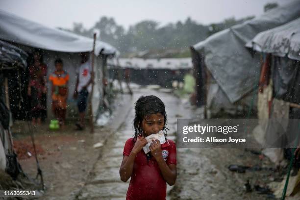 Young Rohingya is seen during a rainstorm at the Nayapara refugee camp on August 21, 2019 in Cox's Bazar, Bangladesh. Rohingya refugees said on...
