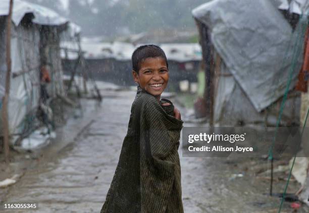 Young Rohingya is seen during a rainstorm at the Nayapara refugee camp on August 21, 2019 in Cox's Bazar, Bangladesh. Rohingya refugees said on...