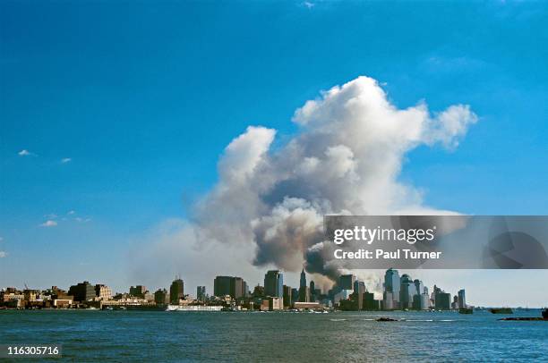 As seen from New Jersey, smoke hangs over South Manhattan after the collapse of the twin towers of the World Trade Center in a terrorist attack, New...