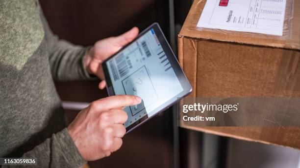 customer signing receipt of home delivery on a tablet - signing tablet stock pictures, royalty-free photos & images