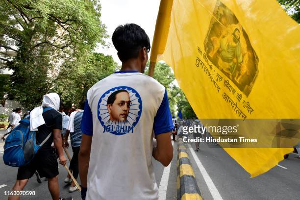 Man seen wearing a BR Ambedkar t-shirt during a protest against the demolition of Sant Ravidas Temple on August 21, 2019 in New Delhi, India. The...