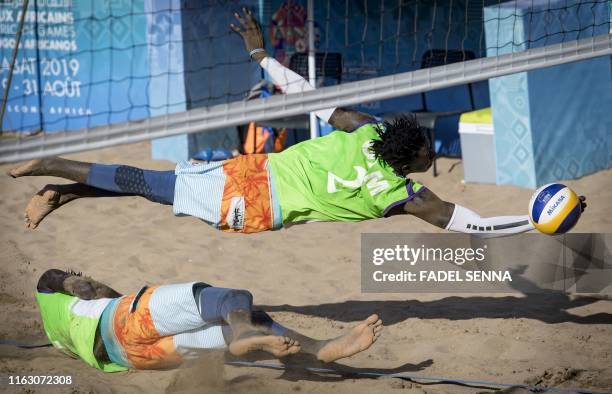 Gambia's Jawo vies for the ball during the men's final beach volleyball at the beach of Sale in Morocco during the 12th edition of the "African...