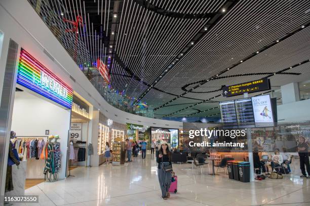 passengers at auckland international airport in new zealand - auckland airport stock pictures, royalty-free photos & images
