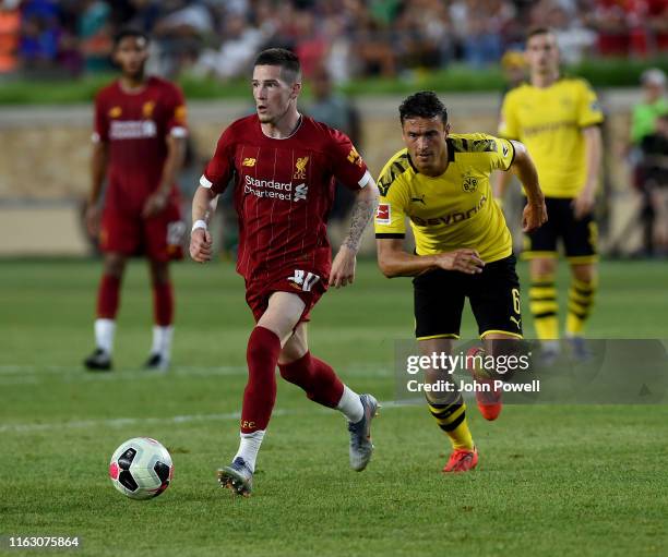 Ryan Kent of Liverpool competes with Thomas Delaney of Borussia Dortmund during the pre-season friendly match between Borussia Dortmund and Liverpool...