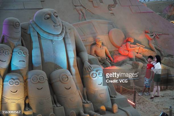 Sand sculptures featuring Minions are on display during the 21st China Zhoushan International Sand Sculpture Festival at Zhujiajian resort on July...