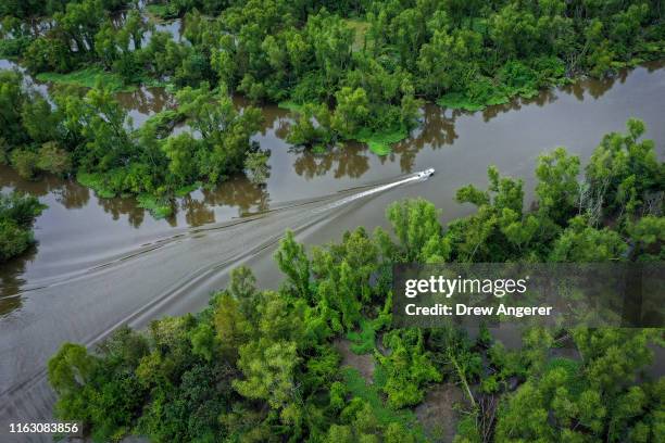 Boat makes its way along the Atchafalaya River in the Atchafalaya Basin, the largest wetland and swamp in the United States, on August 21, 2019 in...