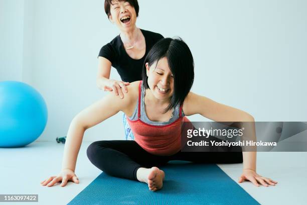 pregnant woman doing exercises with coach - doing a favor stock pictures, royalty-free photos & images