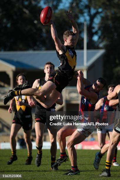 Jack Henderson of Werribee flys over Harvey Hooper of Port Melbourne during the round 16 VFL match between Werribee and Port Melbourne at Avalon...