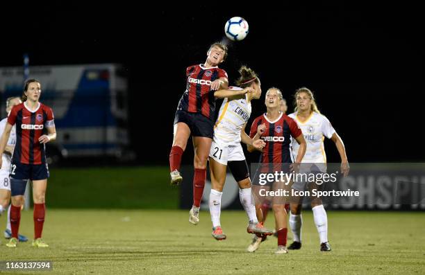 Washington Spirit midfielder Jordan DiBiasi heads a ball with water flying off her head and the ball in front of Utah Royals midfielder Veronica Vero...