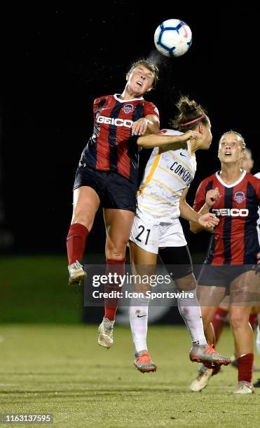 Washington Spirit midfielder Jordan DiBiasi heads a ball with water flying off her head and the ball in front of Utah Royals midfielder Veronica Vero...