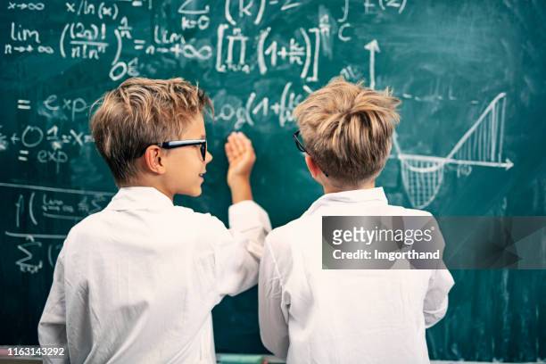 two little scientists discussing science problems - child inventor stock pictures, royalty-free photos & images