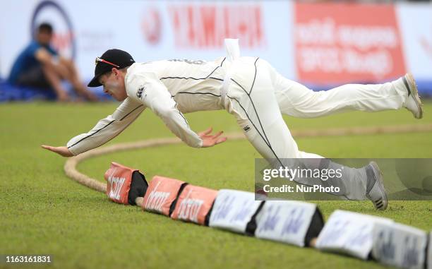 New Zealand cricketer Henry Nicholls fails to stop the ball on the boundary line during the first day's play of the second test cricket match between...
