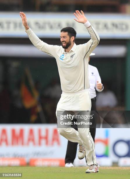 New Zealand cricketer Will Somerville celebrates after taking the wicket of Sri Lankan cricketer Lahiru Thirimanne during the first day's play of the...
