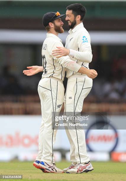 New Zealand cricketer Will Somerville celebrates after taking the wicket of Sri Lankan cricketer Lahiru Thirimanne with New Zealand cricket captain...