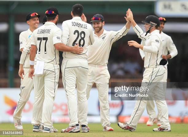 New Zealand cricketer Will Somerville celebrates after taking the wicket of Sri Lankan cricketer Lahiru Thirimanne with New Zealand cricket captain...