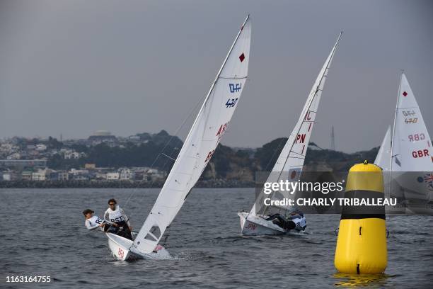 Brazil's Fernanda Oliveira and Ana Barbachan and Japan's Ai Yoshida and Miho Yoshioka compete in the women's two person dinghy 470 class competition...