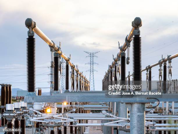 electrical transformer of high tension in a distribution electric power station of electricity power. - power supply stock pictures, royalty-free photos & images